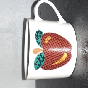Tabletops unlimited Apple mug or tea cup. Microwave and dishwasher safe.